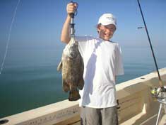 Nick with a nice Tripletail caught working the crab pots north of Marco Island