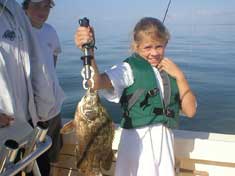 Jazmine hooks up a Tripletail on Marco Island Fishing Charters