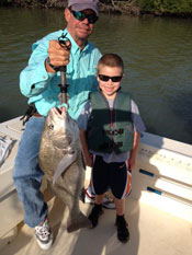 Black Drum caught by father and young son aboard Fins n Grins charter fishing boat on Marco Island