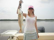 Red fish caught by young woman aboard Fins n Grins - Charter Fishing Marco Island