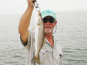 An old pro hooking a Spotted Sea Trout on Marco Island Bay