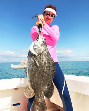 Woman Holding Tripletail on Charter Fishing Boat - Marco Island